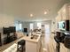 Open-concept kitchen with island bar, stainless appliances, and view into the living area at 2757 Malton Way, Loganville, GA 30052