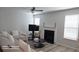Comfortable living room featuring a fireplace, neutral tones, and ample natural light at 2757 Malton Way, Loganville, GA 30052