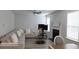 Open-concept living room featuring a comfortable sectional, fireplace, and natural light at 2757 Malton Way, Loganville, GA 30052