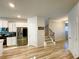 Bright open-concept layout showcasing modern kitchen and staircase at 2757 Malton Way, Loganville, GA 30052