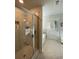 Tiled shower with glass door, soaking tub, and view of the bright bathroom at 2757 Malton Way, Loganville, GA 30052
