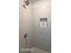 Close up of shower interior with tiled walls, shower head and built-in niche at 2757 Malton Way, Loganville, GA 30052