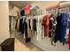 Walk in closet with shelving containing clothes and bedding, and carpet flooring at 2757 Malton Way, Loganville, GA 30052