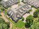 Aerial view showcasing a home with manicured lawn, professional landscaping, and a private drive at 2855 Middlecreek Way # 2855, Cumming, GA 30041
