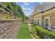 A neatly landscaped backyard featuring a lush garden and a retaining wall at 2855 Middlecreek Way # 2855, Cumming, GA 30041