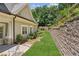 Well-maintained backyard with stone wall, verdant lawn, and charming landscape at 2855 Middlecreek Way # 2855, Cumming, GA 30041