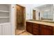 Bathroom with a glass shower, cabinet storage, granite countertop, and tub in the background at 2855 Middlecreek Way # 2855, Cumming, GA 30041