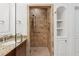 Modern bathroom features a neutral-toned tiled shower and granite countertops at 2855 Middlecreek Way # 2855, Cumming, GA 30041
