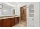 This bathroom features a glass enclosed shower, built-in shelves, and vanity at 2855 Middlecreek Way # 2855, Cumming, GA 30041