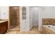 Bathroom featuring a glass-enclosed shower, soaking tub, and granite countertops at 2855 Middlecreek Way # 2855, Cumming, GA 30041