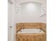 Elegant bathtub with decorative tile surround and stylish fixtures, perfect for relaxation at 2855 Middlecreek Way # 2855, Cumming, GA 30041