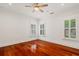 Bright bedroom with hardwood floors, neutral walls, ample natural light, and a ceiling fan at 2855 Middlecreek Way # 2855, Cumming, GA 30041
