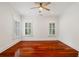 Bright bedroom with hardwood floors, ceiling fan, and windows with shutters at 2855 Middlecreek Way # 2855, Cumming, GA 30041