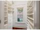 Bright closet with wooden floors, shelving, drawers, and a window for natural light at 2855 Middlecreek Way # 2855, Cumming, GA 30041