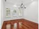 Bright dining room boasts hardwood floors, a modern chandelier, and natural light from windows and door at 2855 Middlecreek Way # 2855, Cumming, GA 30041