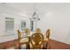 Bright dining room with hardwood floors, modern chandelier, and natural lighting at 2855 Middlecreek Way # 2855, Cumming, GA 30041