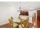 Cozy dining area with glass table, chandelier, hardwood floors, and modern finishes at 2855 Middlecreek Way # 2855, Cumming, GA 30041