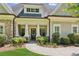 Inviting entrance to this home with manicured landscaping and covered porch at 2855 Middlecreek Way # 2855, Cumming, GA 30041
