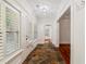 Hallway featuring decorative tile flooring, white trim, and a view into a living space at 2855 Middlecreek Way # 2855, Cumming, GA 30041