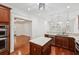 Bright kitchen features stainless steel appliances, granite countertops, an island, and hardwood floors at 2855 Middlecreek Way # 2855, Cumming, GA 30041