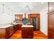 Well-appointed kitchen with stainless steel appliances, wood cabinets, and center island at 2855 Middlecreek Way # 2855, Cumming, GA 30041