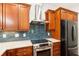 Stylish kitchen with stainless steel appliances, tile backsplash, and wood cabinetry at 2855 Middlecreek Way # 2855, Cumming, GA 30041