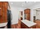 This kitchen offers stainless steel appliances, granite countertops, an island, and hardwood floors at 2855 Middlecreek Way # 2855, Cumming, GA 30041