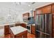 Well-lit kitchen features stainless steel appliances, granite countertops, blue backsplash, an island, and hardwood floors at 2855 Middlecreek Way # 2855, Cumming, GA 30041