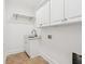 The laundry room features tile floor and white cabinetry and sink at 2855 Middlecreek Way # 2855, Cumming, GA 30041