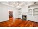Cozy living room with fireplace, built-in shelving, and polished hardwood floors at 2855 Middlecreek Way # 2855, Cumming, GA 30041