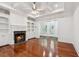 Living room boasts a fireplace, built-ins, coffered ceilings and hardwood floors at 2855 Middlecreek Way # 2855, Cumming, GA 30041