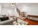 Comfortable living room boasting hardwood floors, a ceiling fan, and access to the stairway at 2855 Middlecreek Way # 2855, Cumming, GA 30041