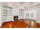 Bright living room with hardwood floors, a fireplace, and access to an outdoor space at 2855 Middlecreek Way # 2855, Cumming, GA 30041