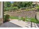 Charming patio featuring stone walls, lush grass, and cozy chairs at 2855 Middlecreek Way # 2855, Cumming, GA 30041
