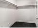 Spacious walk-in closet with ample hanging space and sleek black carpet flooring at 2855 Middlecreek Way # 2855, Cumming, GA 30041