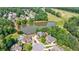 Aerial view of an upscale neighborhood with a lake, golf course, and meticulously maintained landscaping at 652 Pathview Ct, Dacula, GA 30019