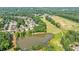 Aerial view of the community with a golf course, pond, and tree-lined streets at 652 Pathview Ct, Dacula, GA 30019