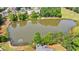 Gorgeous aerial view of home, pond, and lush landscaping with a golf course in the background at 652 Pathview Ct, Dacula, GA 30019
