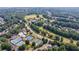 Aerial view of a residential area showcasing the community pool, tennis courts, and neighborhood at 652 Pathview Ct, Dacula, GA 30019