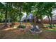 Spacious backyard featuring a fire pit and views of home with deck and patio, with pond in background at 652 Pathview Ct, Dacula, GA 30019