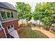 Expansive backyard with a tranquil pond, complemented by lush green lawn and tree-lined perimeter at 652 Pathview Ct, Dacula, GA 30019