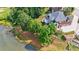 Aerial view of home's backyard, including patio, landscaping, and pond at 652 Pathview Ct, Dacula, GA 30019