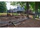 Landscape featuring steps leading up to the backyard and home with a beautiful pond in the background at 652 Pathview Ct, Dacula, GA 30019
