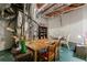 Rustic finished basement features exposed ductwork, a large table, and storage shelves at 652 Pathview Ct, Dacula, GA 30019