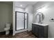 Modern bathroom featuring a sleek black framed glass shower and a stylish vanity with a round mirror at 652 Pathview Ct, Dacula, GA 30019