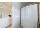 The bright bathroom shows a white shower curtain near a white vanity and mirror at 652 Pathview Ct, Dacula, GA 30019