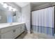 Clean bathroom with a white vanity, modern fixtures, and a neutral-toned shower curtain at 652 Pathview Ct, Dacula, GA 30019