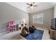 A nice bedroom features a vaulted ceiling, bean bag chairs and a blue geometric rug at 652 Pathview Ct, Dacula, GA 30019