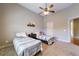 A nice bedroom includes a vaulted ceiling, a ceiling fan and two beds with striped blankets at 652 Pathview Ct, Dacula, GA 30019