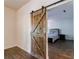 Bedroom with barn door, hardwood floors, and neutral paint creating a peaceful retreat at 652 Pathview Ct, Dacula, GA 30019